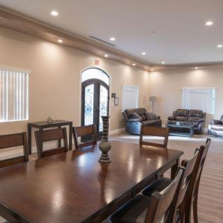 Spacious living and dining area with elegant wooden furniture and comfortable seating.