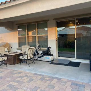 A cozy outdoor patio space featuring comfortable seating, perfect for relaxation in the evening.