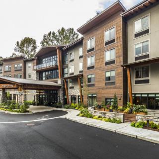 The exterior view of a modern hotel with landscaped surroundings.