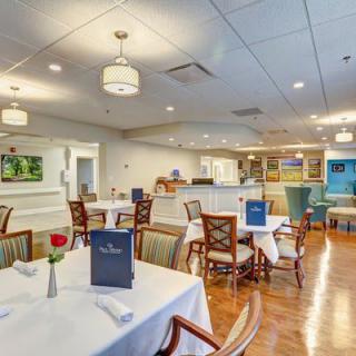 An elegant dining area in a restaurant with neatly arranged tables and comfortable chairs.