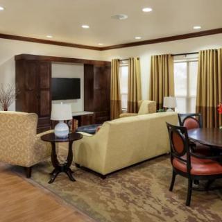 A cozy living room with comfortable seating, a TV, and elegant decor.