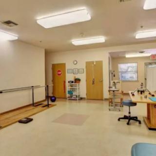 A rehabilitation room equipped with therapy tools and exercise equipment.