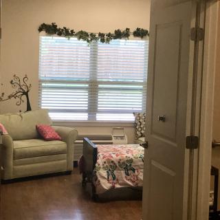 A cozy interior space featuring a bed, couch, and decorative elements.