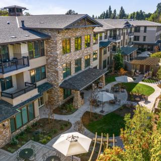 A view of a modern residential building with balconies and a landscaped courtyard.