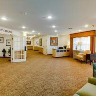 A spacious lobby area with a reception desk and comfortable seating.