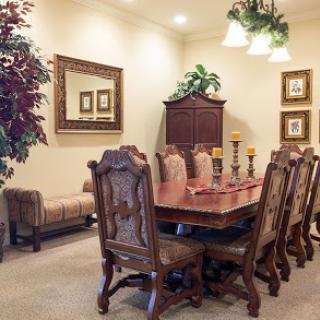 A beautifully designed dining room featuring a large wooden table, elegant seating, and tasteful decor.