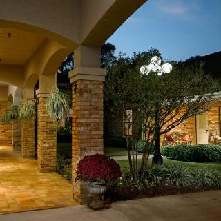 A beautifully lit building with an outdoor garden in the evening.