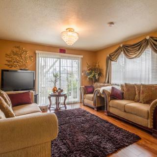 A cozy living room with sofas, a television, and elegant decor.