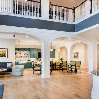 A spacious and modern open-concept living area with a kitchen, dining room, and two-story layout.