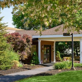 A welcoming entrance surrounded by lush greenery and well-maintained landscaping.