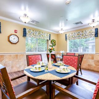A cozy dining room with a well-set table and vibrant decor.