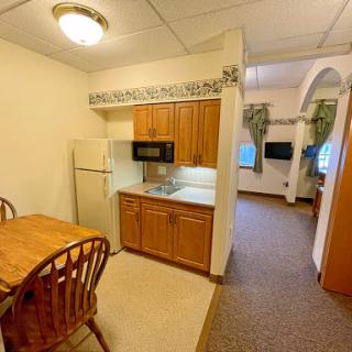 Cozy kitchen area with dining space and essential appliances.