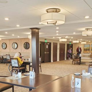 A spacious dining area with tables, chairs, and ambient lighting.
