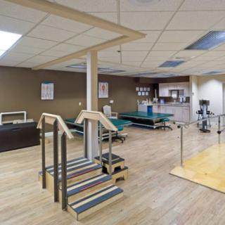 A spacious physical therapy room equipped with various rehabilitation tools.