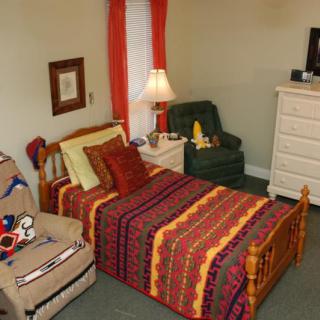 A cozy bedroom with colorful bedding and complementary decor.