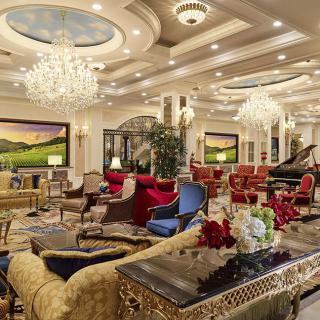 A luxurious hotel lounge with elegant chandeliers and opulent furnishings.