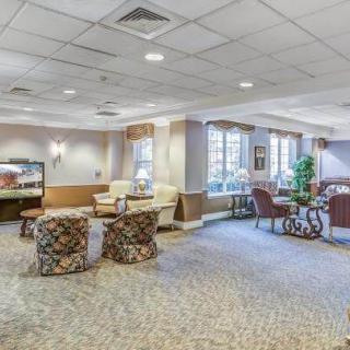 A spacious lounge with comfortable seating and soft lighting.