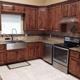 A modern kitchen with wooden cabinets and stainless steel appliances.
