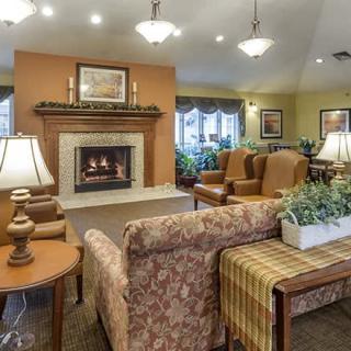 A cozy living room with a fireplace and comfortable seating.