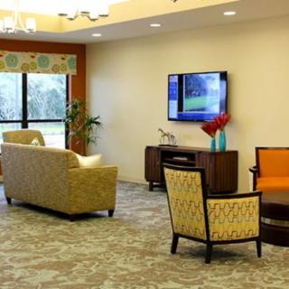 A modern living room with comfortable seating and a mounted television.