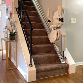 A cozy staircase leading to the upper floor, featuring plush carpeting and a stylish handrail.