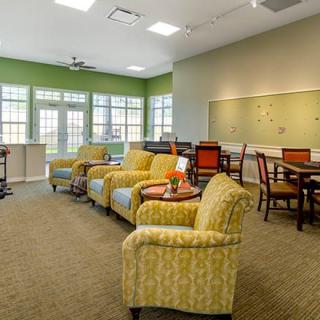 A cozy living area with comfortable seating and bright windows.