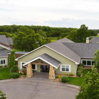 A residential building surrounded by lush greenery.