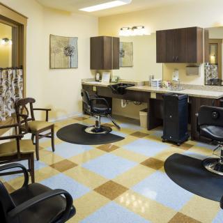 A modern and stylish hair salon interior with chairs and mirrors.