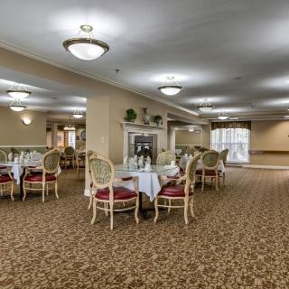 An elegant dining room with neatly arranged tables and chairs.