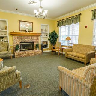 A cozy living room with a fireplace and comfortable seating.