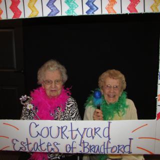 Two seniors enjoying a celebration at Courtyard Estates of Bradford.