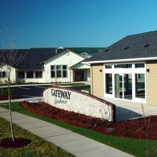 A residential building with a pathway and well-maintained landscaping.