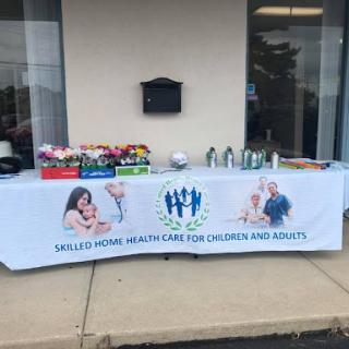 A community healthcare event focused on children's wellness, featuring a table with resources and refreshments.