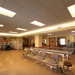 A spacious and well-lit interior of a hospital waiting area with seating arrangements.