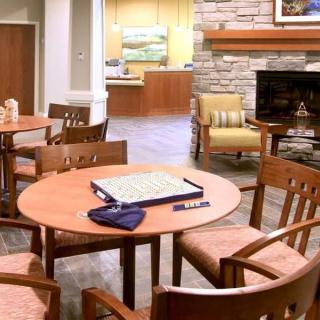 A cozy lounge area with wooden furniture and a fireplace.