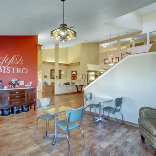 A cozy bistro interior with colorful chairs and modern decor.