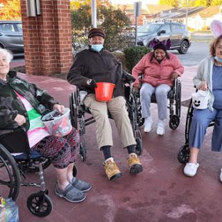 Residents enjoying some time outdoors together at a care facility.