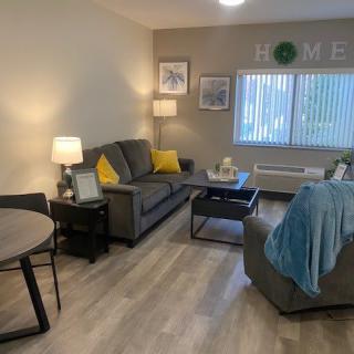 A cozy living room with a modern design, featuring comfortable sofas and stylish lighting.