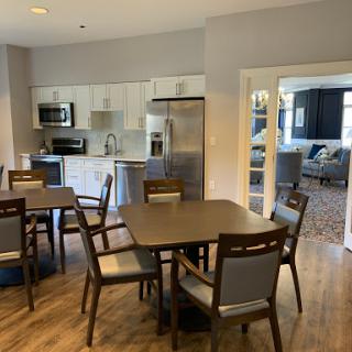 A modern kitchen and dining area featuring an open layout with contemporary furniture.
