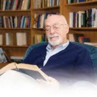 A man reading in a library setting.