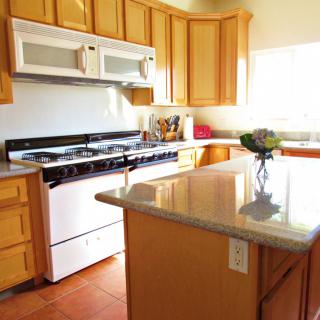 A bright and modern kitchen with wooden cabinets and a center island.