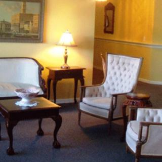A traditional living room arrangement with classic furniture and warm lighting.