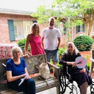 A heartwarming moment shared among family members on a sunny porch.