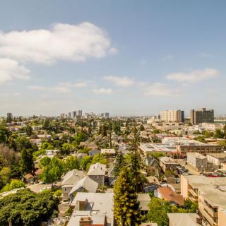 A scenic view of a city skyline under a partly cloudy sky.