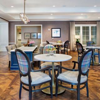 A cozy living and dining area with elegant furniture and soft lighting.