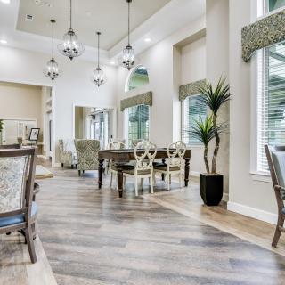 A beautifully decorated dining room with modern furniture and elegant lighting.