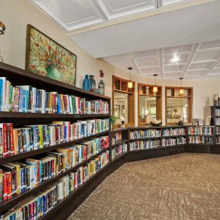 A cozy library with rows of bookshelves and a well-lit interior.