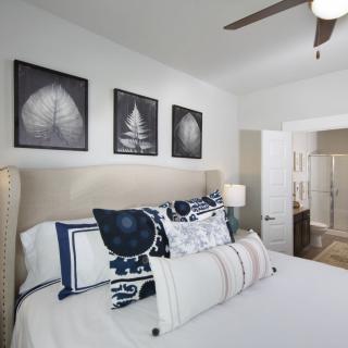 A modern bedroom with stylish decor and comfortable bedding.