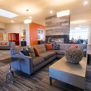 A modern living room with stylish furniture and a cozy fireplace.