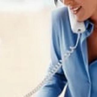 A person engaged in a telephone conversation at the office.